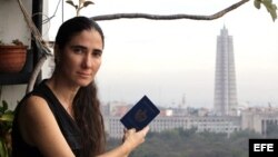 Yoani, en el balcón de su apartamento, pasaporte en mano