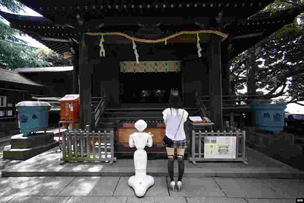 Tomomi Ota y su robot en un templo de Tokio. 