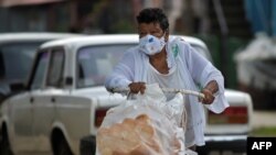 Una mujer sale a las calles de La Habana a vender pan en tiempos de coronavirus, el 22 de junio de 2020. (Yamil Lage / AFP).