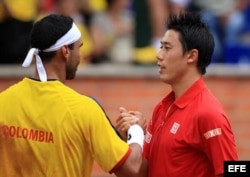 Kei Nishikori (d) estrecha la mano de Alejandro Falla.
