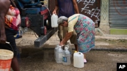 Una anciana busca agua en La Habana.
