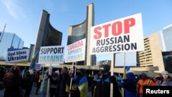 Ukrainian supporters rally after Russia launched a massive military operation against Ukraine, in Toronto