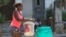 Una mujer traslada un tanque en una carretilla para abastecerse de agua ante la crisis de suministro en la capital cubana