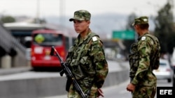 Dos militares colombianos custodian una calle hoy, sábado 31 de agosto de 2013, cerca a una estación del sistema masivo de transporte TransMilenio, en Bogotá (Colombia)