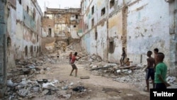 Niños juegan pelota en un edificio en ruinas en La Habana. 