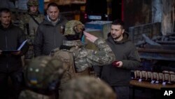 El presidente de Ucrania, Volodymyr Zelenskyy, a la derecha, el 20 de diciembre de 2022 en Bakmut, Ucrania. (Ukrainian Presidential Press Office via AP).