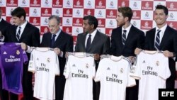El presidente del Real Madrid, Florentino Pérez (2i), y jugadores del equipo, muestran la nueva camiseta que lucirá el club blanco, tras firmar hoy un acuerdo de patrocinio para los próximos cinco años.