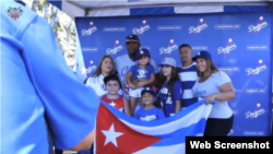 El jardinero central de los Dodgers, el cubano Yasiel Puig, se toma una foto con varios de sus admiradores durante el Día de la Herencia cubana en el estadio de los Dodgers.
