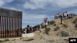 Seguidores del partido republicano hacen un muro humano para manifestarse a favor de la construcción de una barrera física en la frontera con México. 