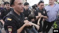 ARCHIVO. La policía antidisturbios detienen a una chica que participaba en la marcha de la oposición en Moscú.
