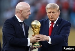 El presidente de EE. UU., Donald Trump, y el presidente de la FIFA, Gianni Infantino, con el trofeo de la Copa Mundial durante la ceremonia de entrega. REUTERS/Lee Smith