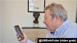 El jefe de la misión diplomática de EEUU en Cuba, Mike Hammer, habla con Doris, esposa de Ernesto Ricardo Medina, uno de los miembros de El4tico.