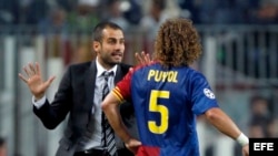 El defensa del F. C. Barcelona, Carles Puyol (d), atiende a las indicaciones del entrenador del equipo blaugrana, Pep Guardiola.