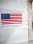Patients wait inside a tent with a US flag reading "Sponsored by the United States" at the US Samaritan's Purse field hospital in La Guaira, Venezuela on July 10, 2026, following the June 24 twin earthquakes.