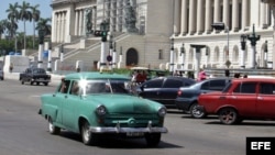 Un auto clásico pasa frente a la sede del capitolio cubano.