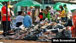 Vendedores de zapatos en un área al aire libre.