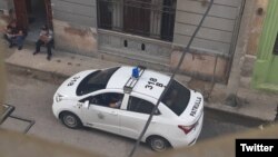 Una patrulla policial en los bajos del edificio donde vive la curadora Anamely Ramos, en La Habana. (Twitter/Movimiento San Isidro)