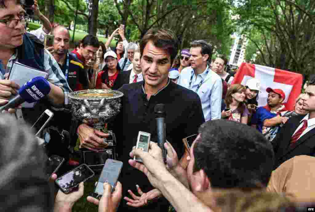 El suizo Roger Federer responde a las preguntas de los medios de comunicación después de una sesión de fotos con el trofeo ganado en el Abierto de Australia en el Carlton Gardens de Melbourne, Australia, el 30 de enero de 2017. Federer derrotó al español Rafael Nadal en el partido final. &nbsp;