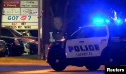 Autos policiales en torno al cine Grand 16 de Lafayette, Louisiana, donde un atacante dio muerte a dos personas.
