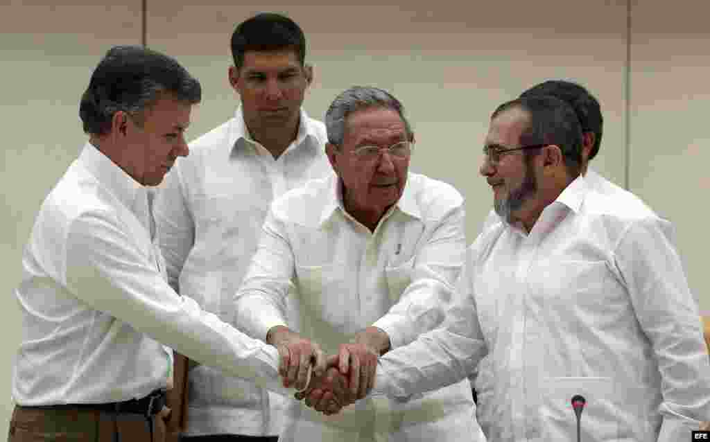 Raul Castro abraza a Juan Manuel Santos y al líder de las FARC, Rodrigo Londoño, alias "Timochenko", tras la firma del acuerdo.