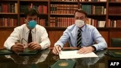 Jair Bolsonaro (derecha) usando una mascara protectora contra el coronavirus en un programa de TV.