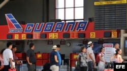 Varias personas hacen cola en el mostrador de la aerolínea Cubana de Aviación, en el aeropuerto José Martí, de La Habana (Cuba). 