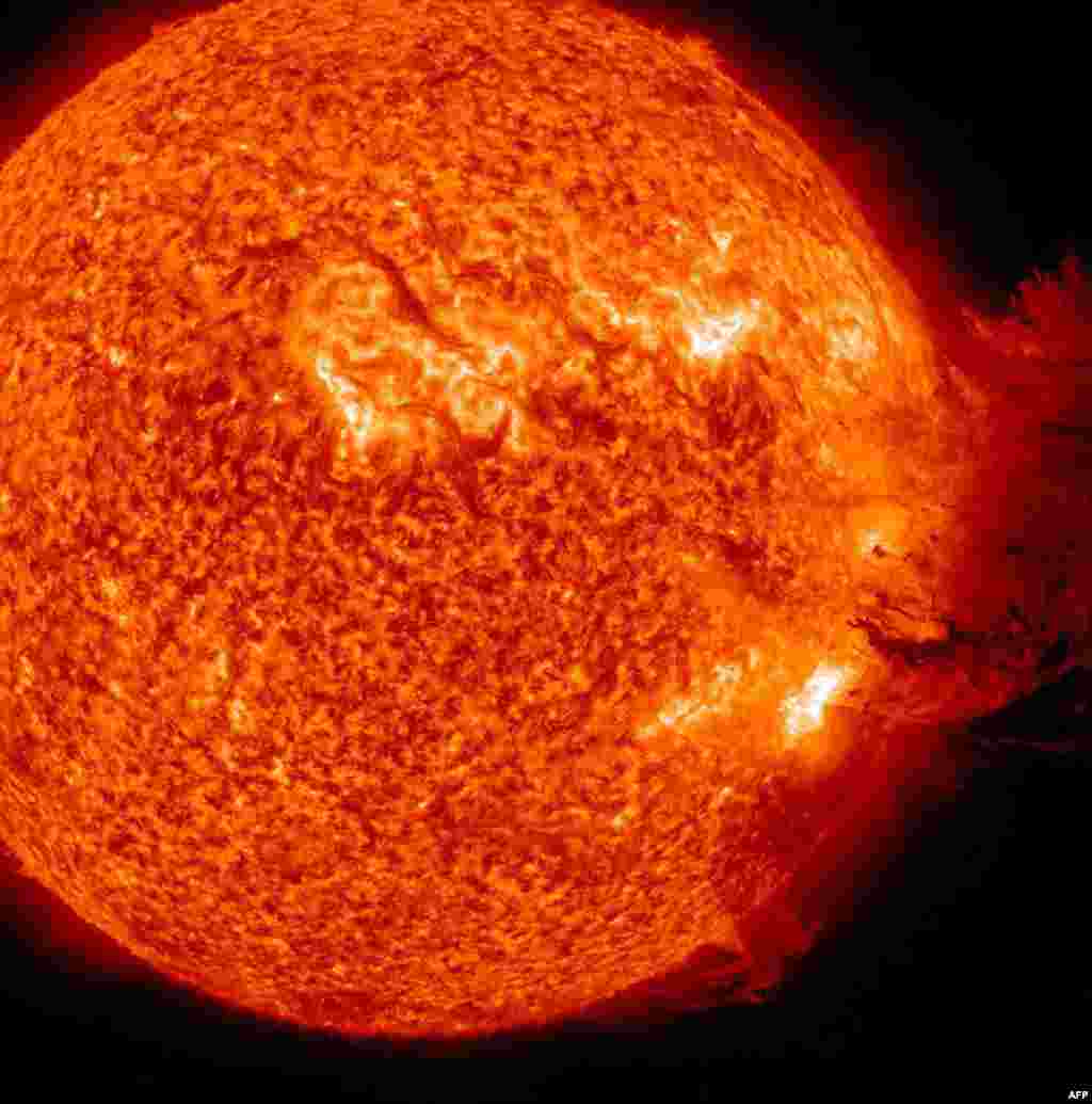 Space -- The Sun unleashing an M-2 solar flare, an S1-class radiation storm and a coronal mass ejection resulting in a large cloud of particles mushrooming up and falling back down, 07Jun2011