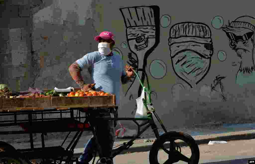 Un vendedor de vegetales en una calle de La Habana usa una m&#225;scara para protegerse del coronavirus. (YAMIL LAGE / AFP)