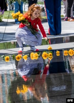 Una niña deposita flores en el Monumento a los Héroes Caídos, en Boston, Massachusetts.
