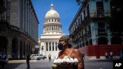Una mujer lleva un cartón de huevos en La Habana, en medio de la pandemia.