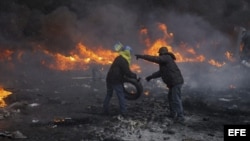 Unos manifestantes lanzan cócteles molotov a la polícia durante los enfrentamientos en el centro de Kiev, Ucrania.