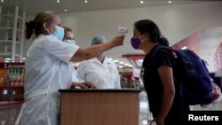 Viajeros se someten a chequeo de temperatura corporal a su arribo al Aeropuerto Internacional José Martí, en La Habana. REUTERS/Alexandre Meneghini/File 