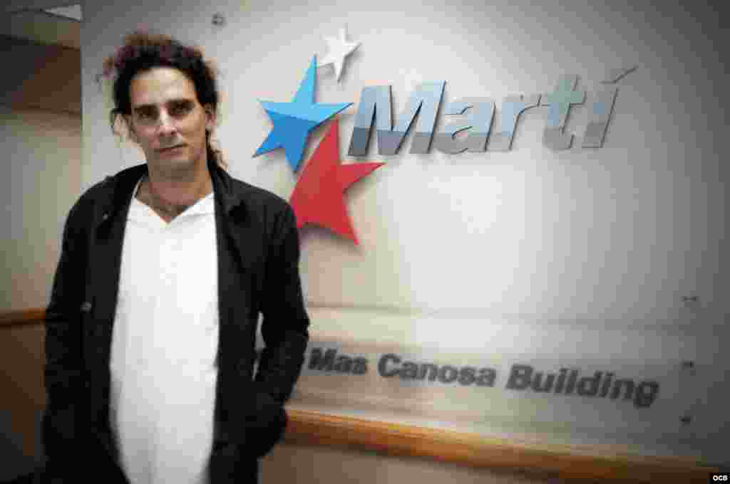 Orlando Luis Pardo stands in front of the Martí sign at OCB 