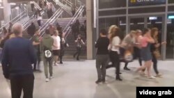 Jóvenes asistentes al concierto de Ariana Grande escapan corriendo del Manchester Arena después del atentado terrorista que dejó al menos 22 muertos.