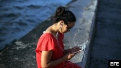 Una joven se conecta a internet en el muro del Malecón, en La Habana. 