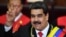Venezuela's President Nicolas Maduro flashes the victory sign after being sworn-in for his second mandate