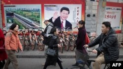 propaganda poster of China's President Xi Jinping on a wall in Beijing