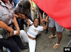 Yaquelin Boni, de las Damas de Blanco es detenida, entre hostigamiento e insultos de sectores oficialistas el 10 de diciembre de 2015, en La Habana (Cuba).