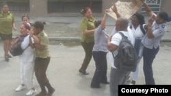 Arresto de Damas de Blanco y un activista frente a la sede del grupo opositor, este domingo 11 de marzo.