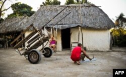 Un campesino trabaja frente a su bohío en el poblado de Jiguaní, en la provincia de Granma.