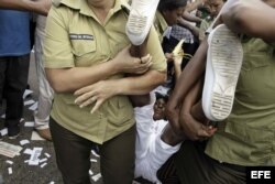 Una Dama de Blanco es arrestada por manifestarse pacíficamente en una calle de La Habana.