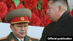 Kim Jong Un (d) y su tío político Jang Sung Taek antes de que el segundo fuera purgado y ejecutado.
