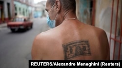 Un hombre muestra un tatuaje de un dólar en su espalda, en La Habana. (REUTERS/Alexandre Meneghini)