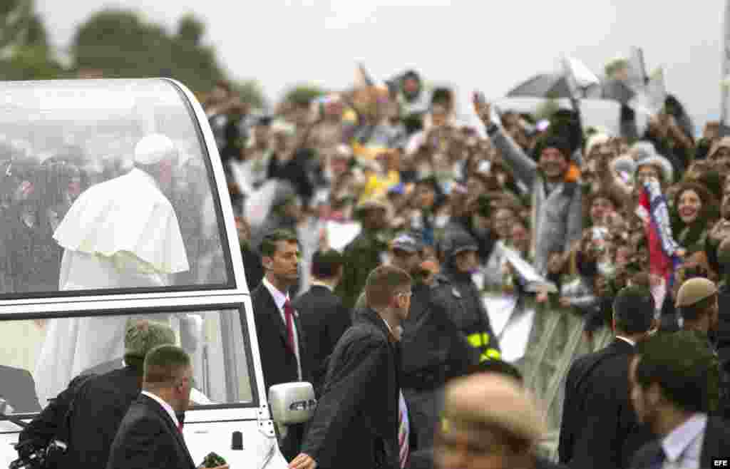 &nbsp;El papa Francisco (c) saluda a fieles durante su recorrido al Santuario Nacional de Nuestra Señora de Aparecida hoy, 24 de julio de 2013, en la ciudad de Aparecida, a 196 kilómetros de Sao Paulo (Brasil). El pontífice oficiará hoy su primera misa en Brasil a donde llegó el pasado 22.