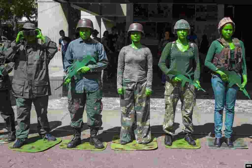 Un grupo de estudiantes de la Universidad Experimental de Arte (UNEARTE) protestan caracterizados como militares en contra de la represión militar a estudiantes y civiles hoy, viernes 11 de abril del 2014, en Caracas (Venezuela).