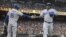 Foto de archivo. Yasiel Puig es felicitado tras anotar una carrera contra los Gigantes de San Francisco.