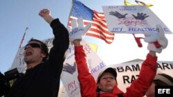 Un partidario (Izq) y una opositora (Dcha) de la reforma sanitaria frente a la Corte Suprema, que estudia los alegatos contra la reforma de la sanidad, el 27 de marzo en Washington DC, Estados Unidos.