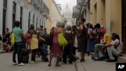 Cubanos hacen cola para comprar alimentos. Muchos trabajadores en la isla están varios meses esperando que les sean pagados sus salarios.