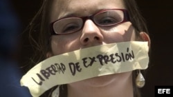 Archivo - Una mujer protesta en Caracas (Venezuela) frente a la sede de la Comisión Nacional de Telecomunicaciones (CONATEL). 