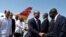 El primer ministro de Haití, Laurent Salvador Lamothe (c), saluda a varios oficiales cubanos acompañado por el vicecanciller de Cuba, Rogelio Sierra (i), a su llegada al aeropuerto habanero "José Martí" de La Habana (Cuba)